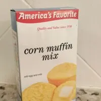 A box of corn muffin mix on a counter with the words 