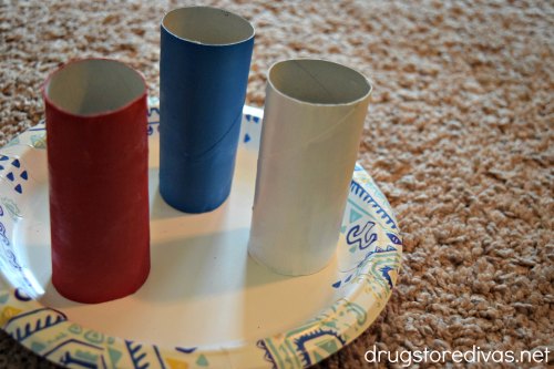 A red, white, and blue toilet paper roll tube on a paper plate.