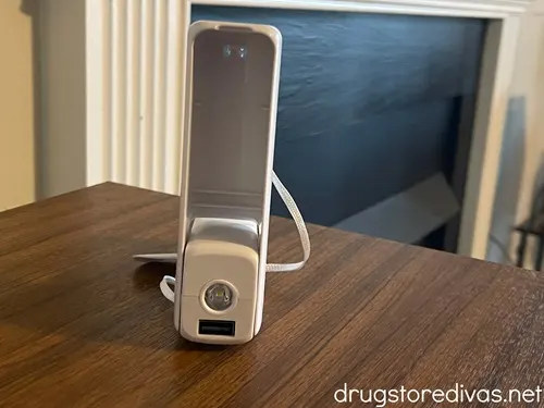 A small flashlight stand on a wooden table.