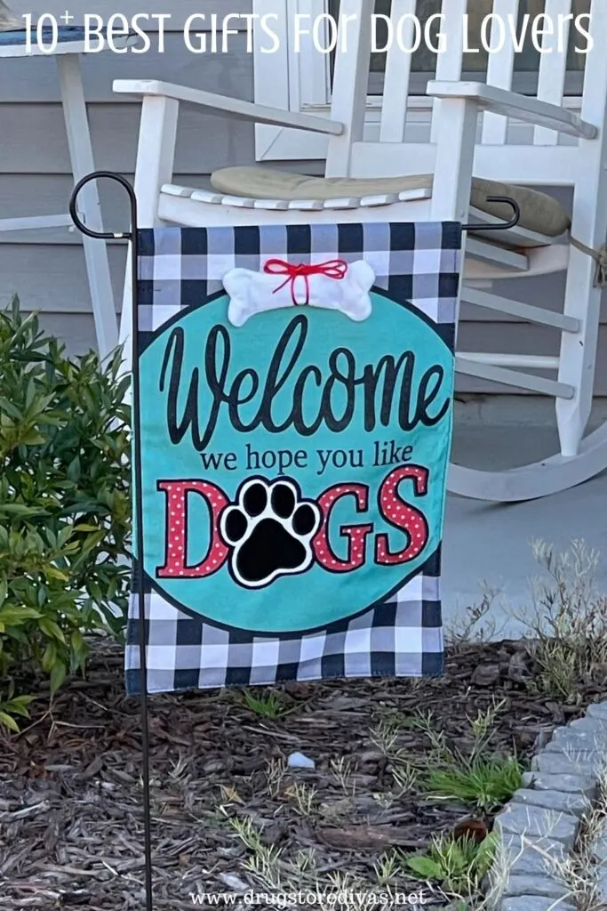 A flag that says "Welcome we hope you like dogs" on a porch with the words "10+ Best Gifts For Dog Lovers" digitally written on top.