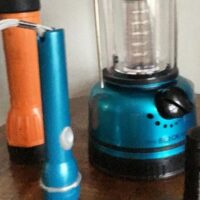 Two flashlights and a lantern on a table with the words 
