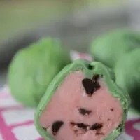 A Watermelon Cake Pop opened on a plate with the words 
