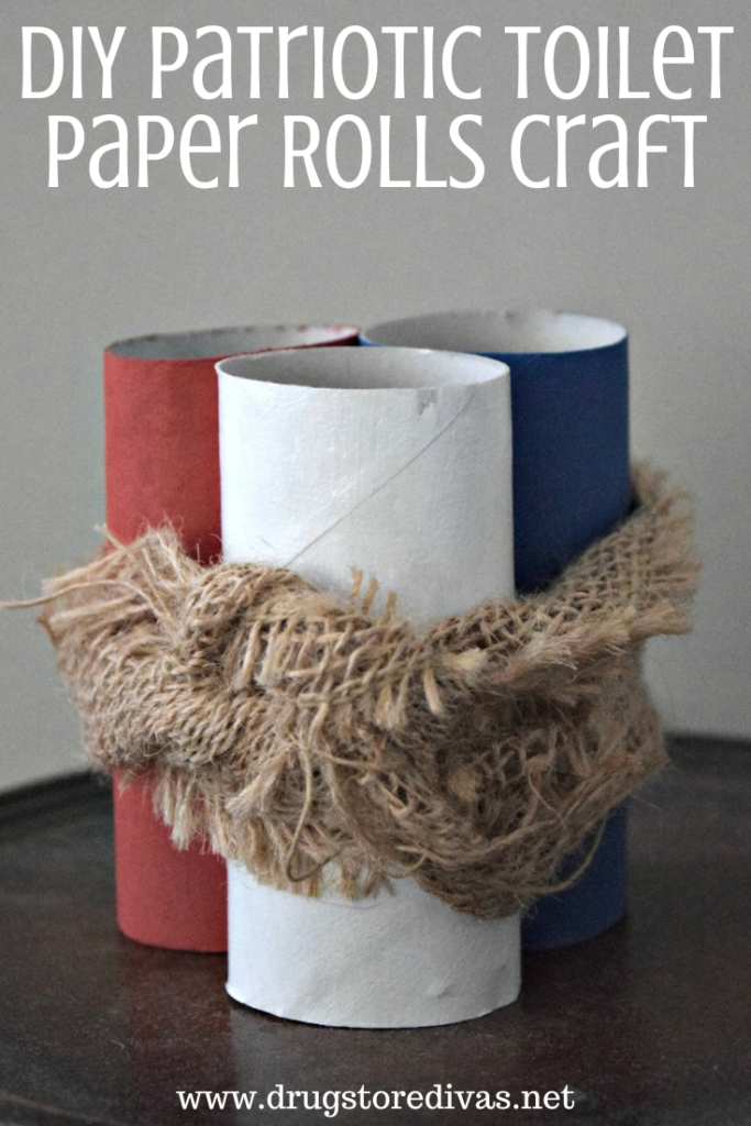 Three toilet paper rolls, painted red, white, and blue, with burlap tying them together and the words "DIY Patriotic Toilet Paper Rolls Craft" digitally written above it.