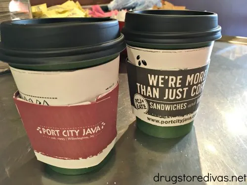 Two disposable coffee cups in a coffee shop.