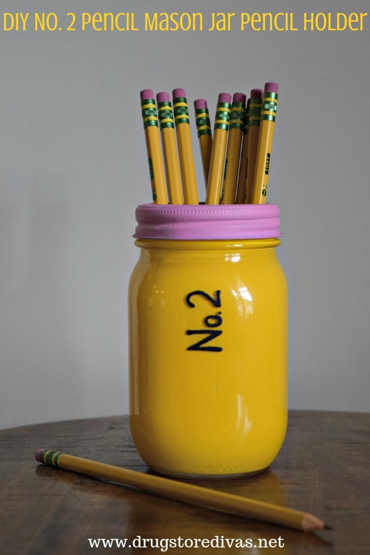 A mason jar painted to look like a pencil, with pencils sticking out the top, and the words "DIY No. 2 Pencil Mason Jar Pencil Holder" digitally written on top.