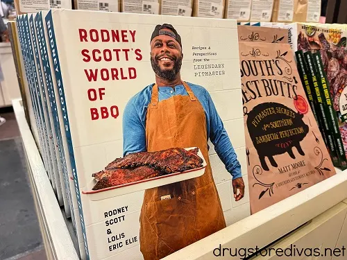 Rodney Scott's World Of BBQ cookbook on a shelf.