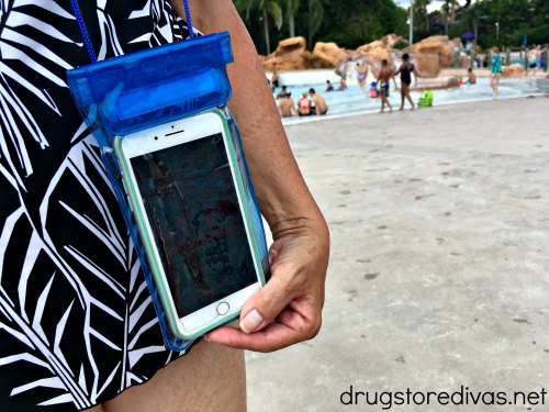 A woman holding a waterproof phone pouch.