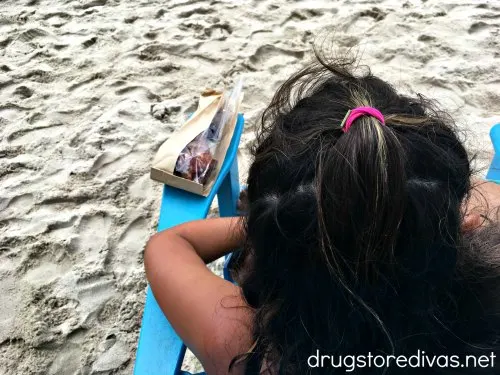 The back of a woman's head showing her hair tie.