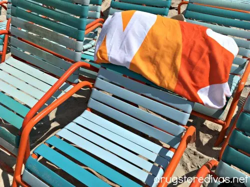 A towel on the back of a beach chair.