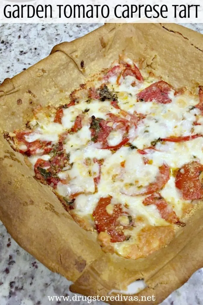 Tomatoes and cheese in a puffed pastry tart with the words "Garden Tomato Caprese Tart" digitally written on top.