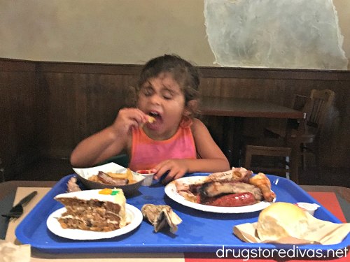 A girl eating barbecue at Voyager's Smokehouse in SeaWorld Orlando.