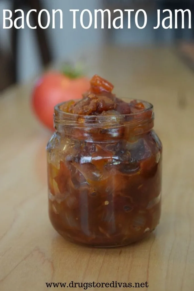 Bacon Tomato Jam in a jar with a tomato behind it and the words "Bacon Tomato Jam" digitally written on top.