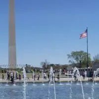 The Washington Monument and an American flag in Washington, DC with the words 
