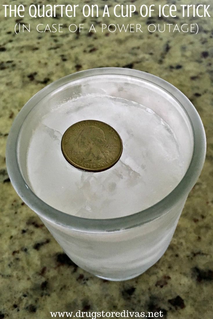 A quarter on a top of frozen ice in a cup.