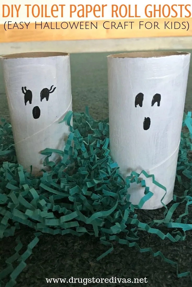 Two toilet paper rolls painted to look like ghosts with the words "DIY Toilet Paper Roll Ghosts (Easy Halloween Craft For Kids)" digitally written on top.