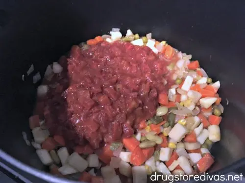 Diced tomatoes in a pot with mixed vegetables.