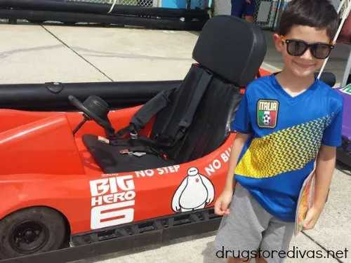 Young boy in front of a go kart.