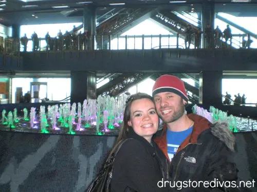 Two people in front of an indoor water show.