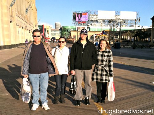Four people with shopping bags standing on the boardwalk.