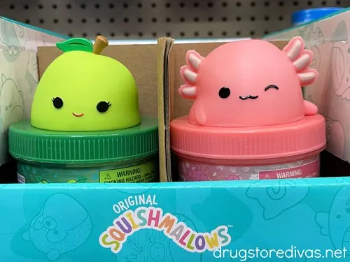 A green pear and pink axolotl capped jar of slime.