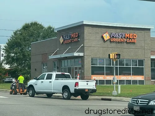 A truck in front of an Urgent Care center.
