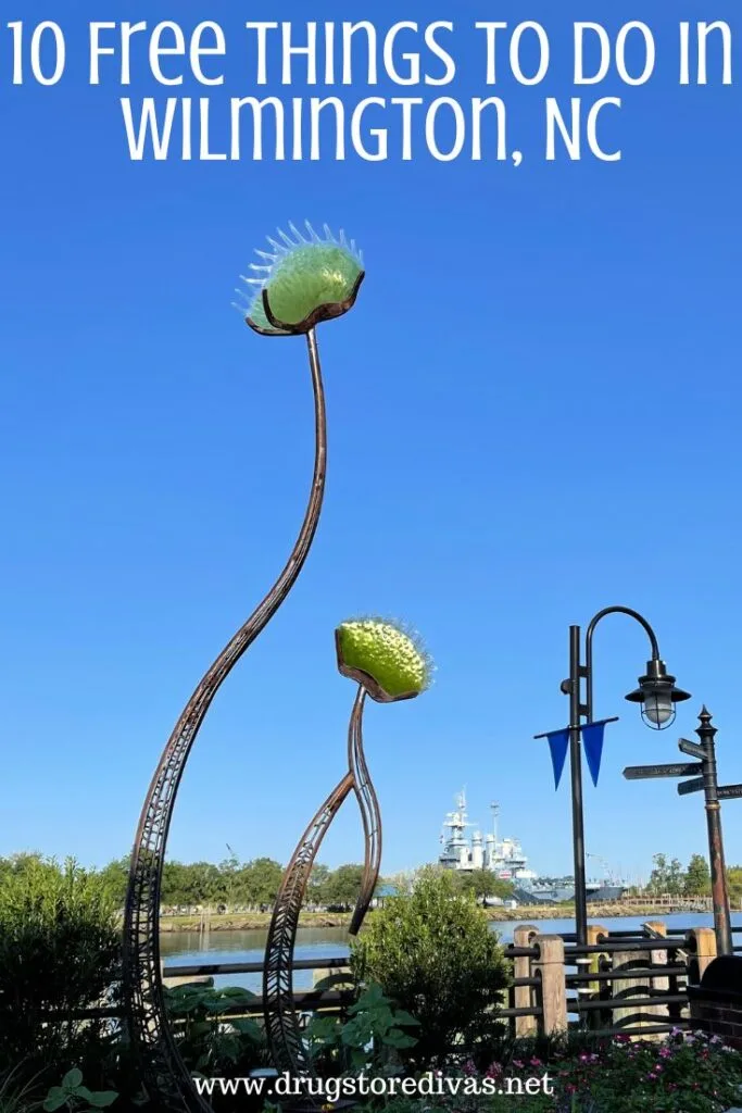 Two venus flytrap statues over a river with a battleship in the back with the words "10 Free Things To Do In Wilmington, NC" digitally written on top.