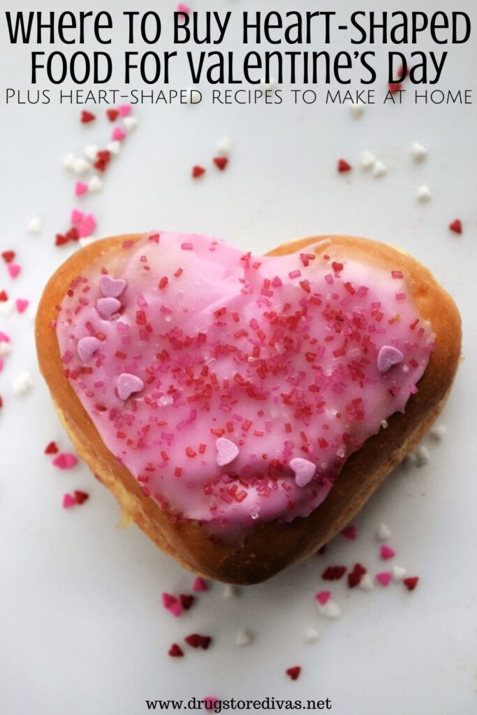 A heart doughnut surrounded by sprinkles with the words "Where To Buy Heart-Shaped Food For Valentine's Day" digitally written on top.