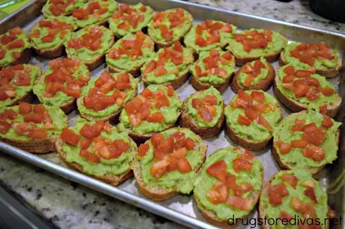 Avocado Toast Bruschetta is the perfect party appetizer. It's vegan too! Find out how to make it at www.drugstoredivas.net.