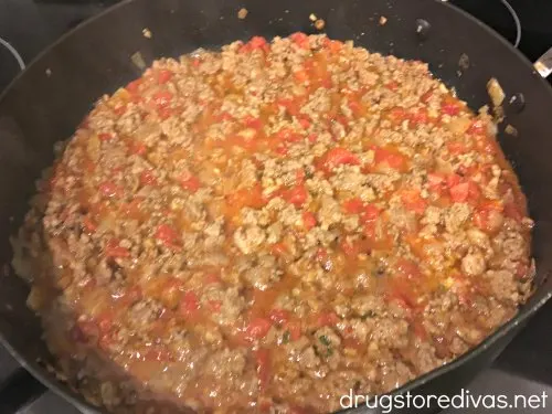 Sausage Stuffed Spaghetti Squash will be your new favorite low carb dinner. Get the recipe, and find out how to easily cut spaghetti squash, on www.drugstoredivas.net.