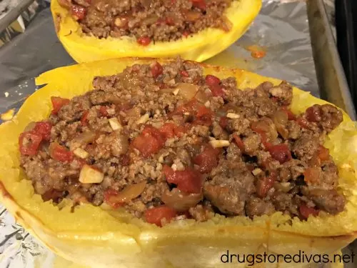 Sausage Stuffed Spaghetti Squash will be your new favorite low carb dinner. Get the recipe, and find out how to easily cut spaghetti squash, on www.drugstoredivas.net.