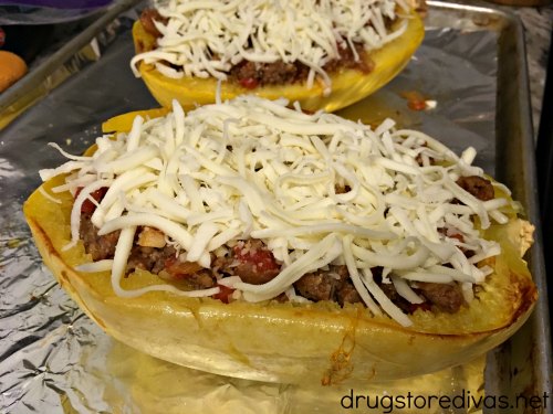 Sausage Stuffed Spaghetti Squash will be your new favorite low carb dinner. Get the recipe, and find out how to easily cut spaghetti squash, on www.drugstoredivas.net.