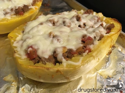 Sausage Stuffed Spaghetti Squash will be your new favorite low carb dinner. Get the recipe, and find out how to easily cut spaghetti squash, on www.drugstoredivas.net.