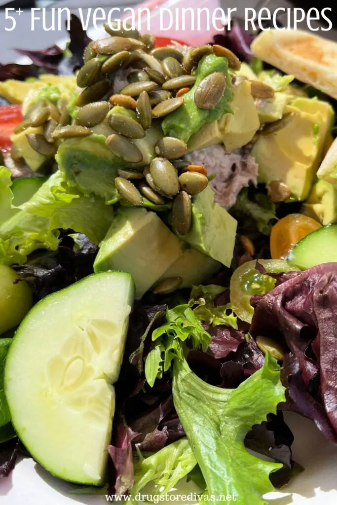 A green salad with the words "5+ Fun Vegan Dinner Ideas" digitally written on top.