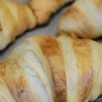 Four croissants with the words 