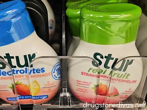 Two Stur Water Enhancer bottles on a shelf.