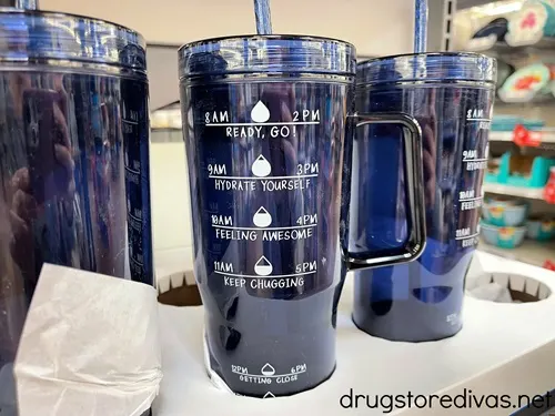 Water bottles with time markers on them on the shelf in a store.