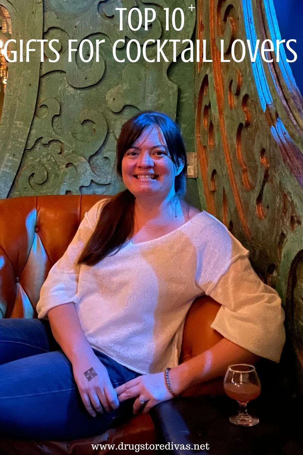 A woman in a white shirt and jeans sitting on a couch with a cocktail on a table in front of her and the words 