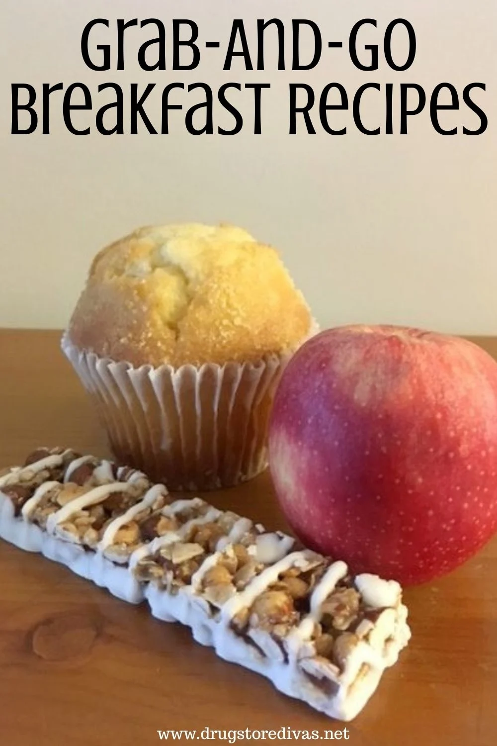 A granola bar, red apple, and muffin on a table with the words "Grab-And-Go Breakfast Recipes" digitally written on top.