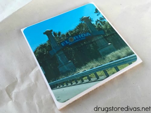 Photo of the Welcome To Florida sign on a tile to make a homemade photo coaster.
