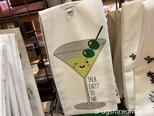 A kitchen towel with a cartoon martini glass with two olives that says "Talk Dirty To Me."