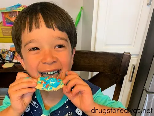 A boy eating a cookie.