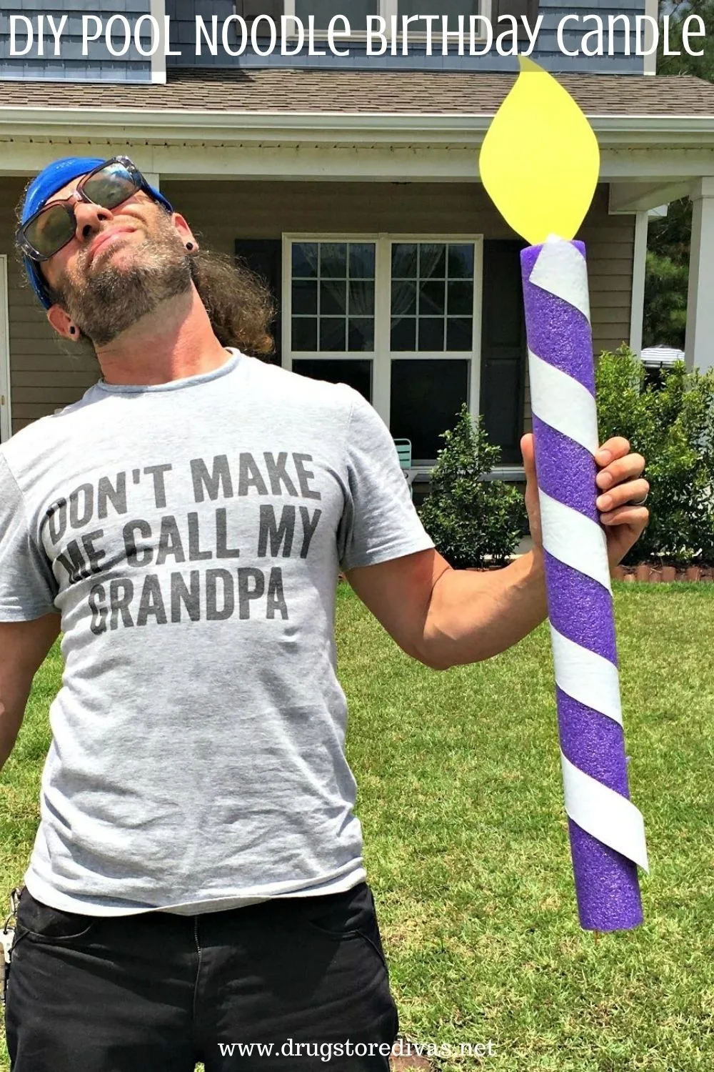 A man holding a homemade birthday candle with the words 