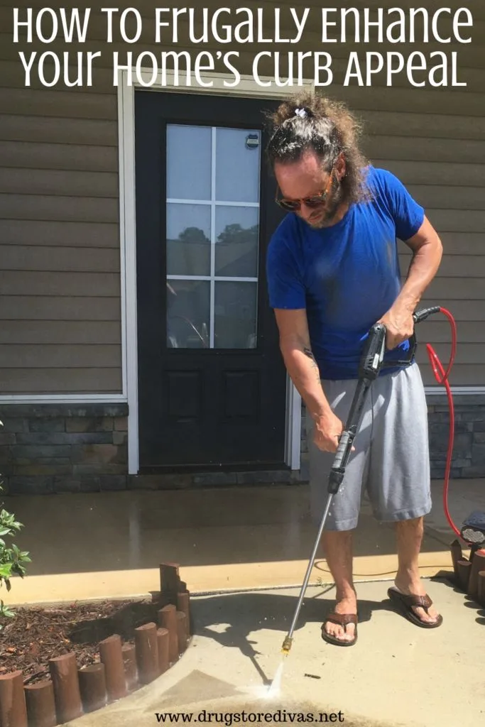 A man power washing a home's walkway with the words "How To Frugally Enhance Your Home's Curb Appeal" digitally written on top.