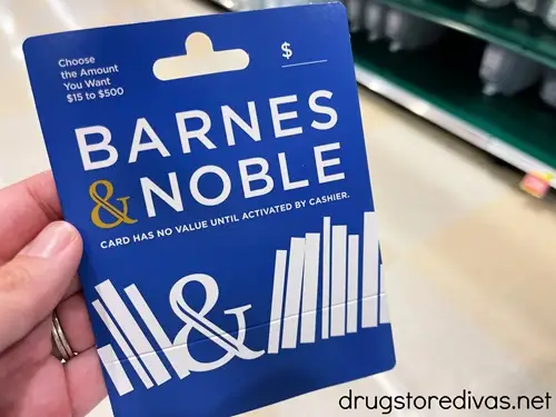 A hand holding a Barnes & Noble gift card.
