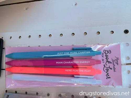 A set of four pens with book themed sayings on them.