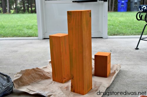 Three pieces of wood painted orange.
