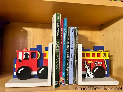 Fire truck book ends with books between them.
