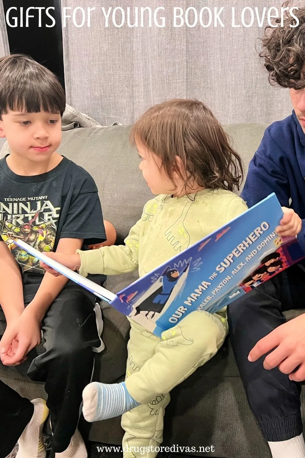 Three boys reading a book with the words 