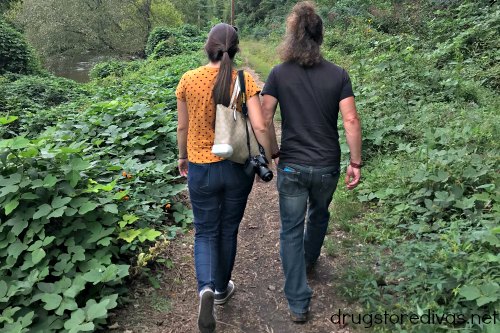 Two people on a walk in the woods.