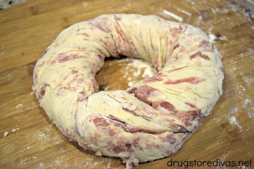 Prosciutto bread dough rolled into a ring shape, 